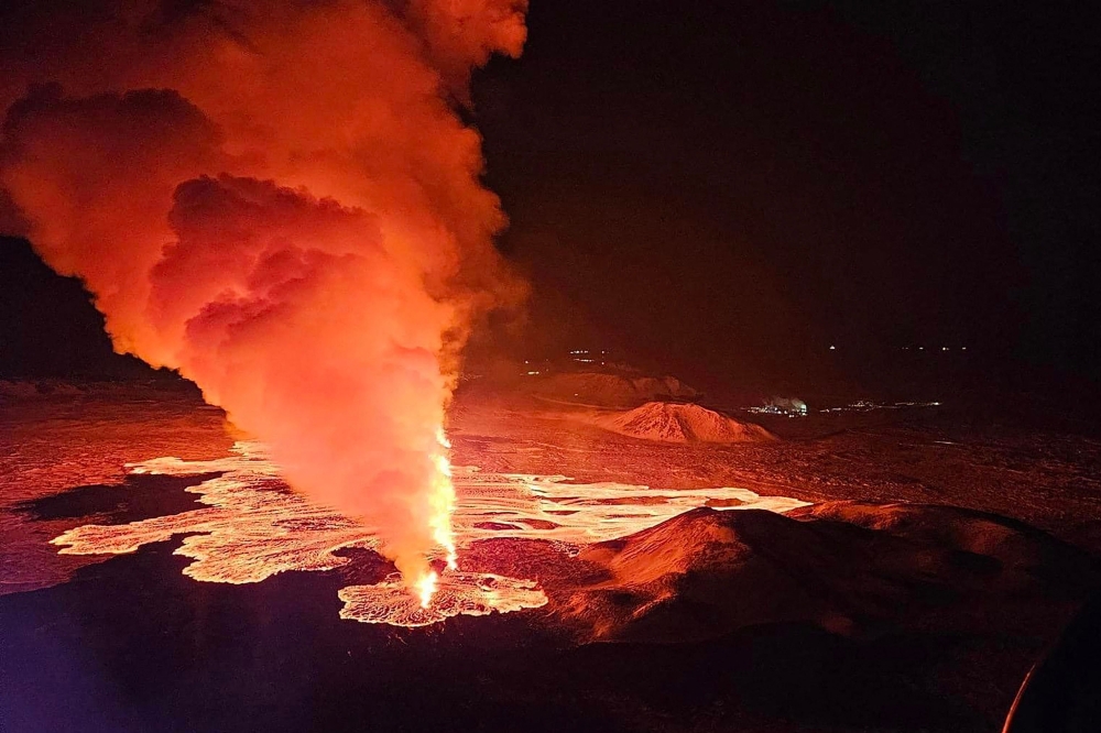 Billowing smoke and flowing lava are seen pouring out of a new fissure in this Icelandic Department of Civil Protection and Emergency Management , February 8, 2024, handout image during a new volcanic eruption on the outskirts of the evacuated town of Grindavik, western Iceland. Photo by Icelandic Department of Civil Protection and Emergency Management / AFP