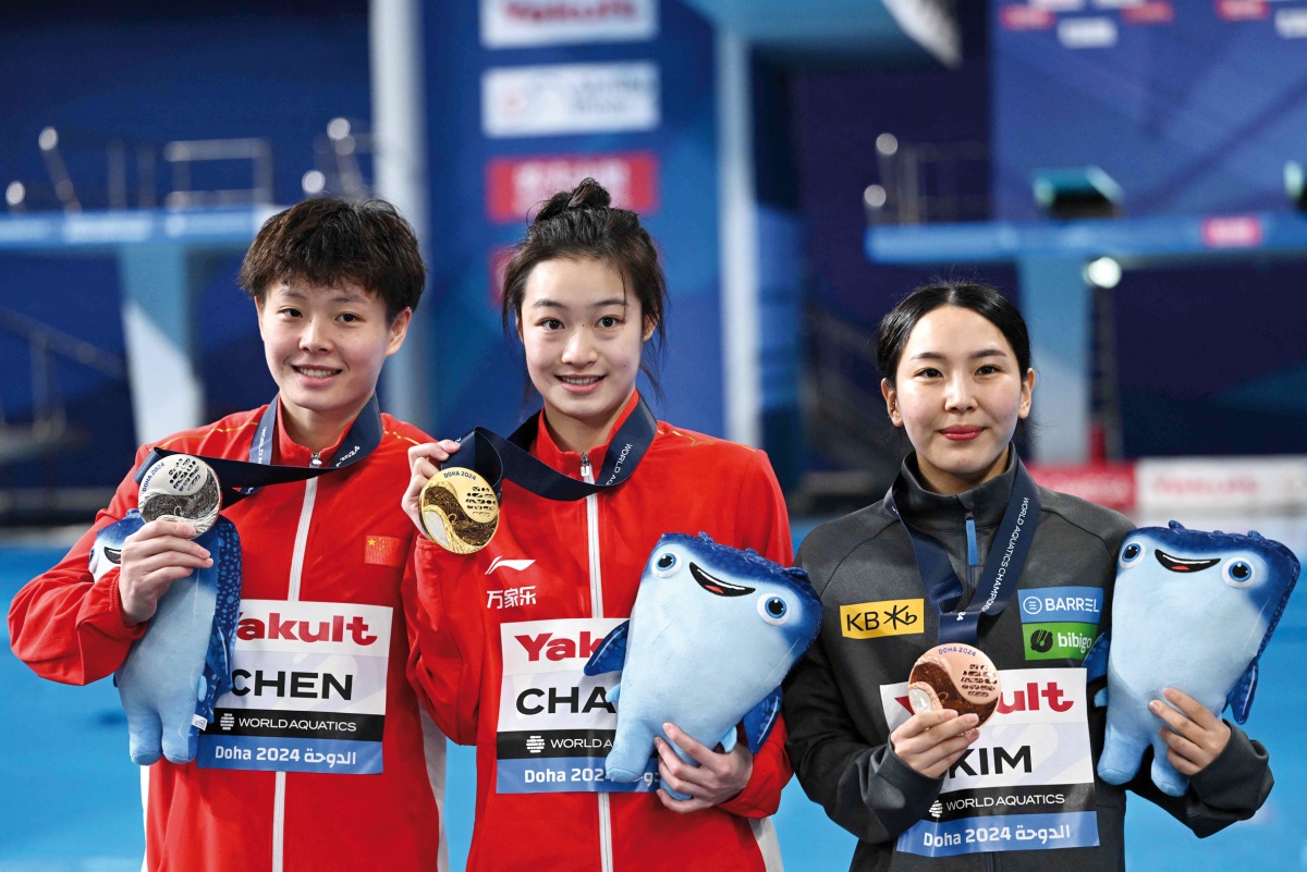 Gold medallist China’s Chang Yani (centre), silver medallist China’s Chen Yiwen (left) and bronze medallist South Korea’s Kim Su-ji pose after the medal ceremony yesterday. AFP 