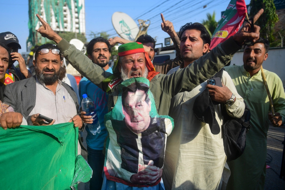Supporters of Khan's Pakistan Tehreek-e-Insaf (PTI) party protest against the alleged skewing in Pakistan's national election results, in Karachi on February 11, 2024. (Photo by Asif Hassan / AFP)