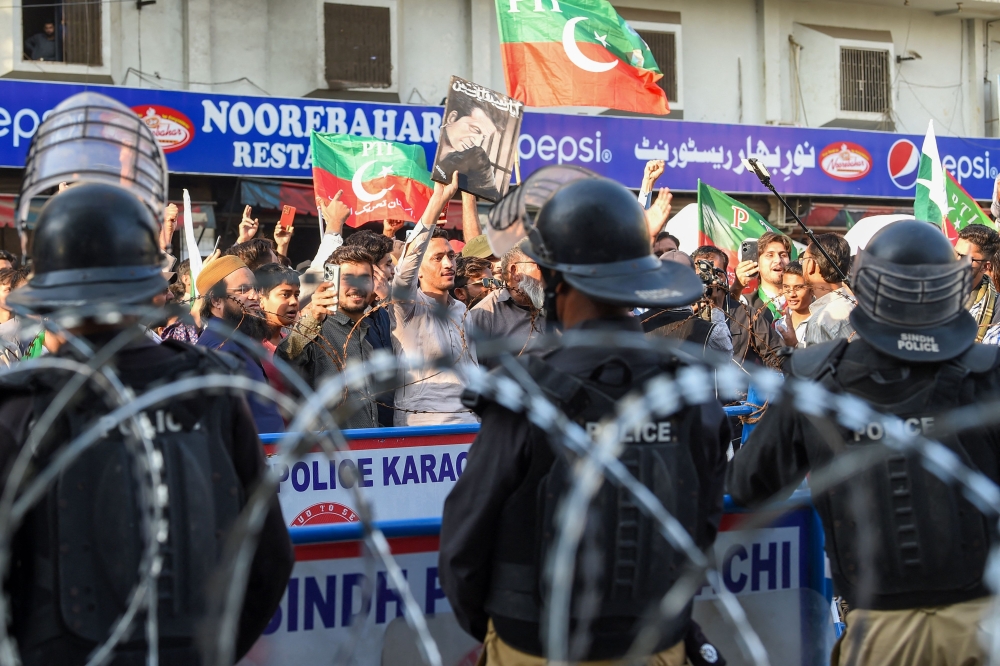 Supporters of Khan's Pakistan Tehreek-e-Insaf (PTI) party protest against the alleged skewing in Pakistan's national election results, in Karachi on February 11, 2024. (Photo by Asif HASSAN / AFP)
