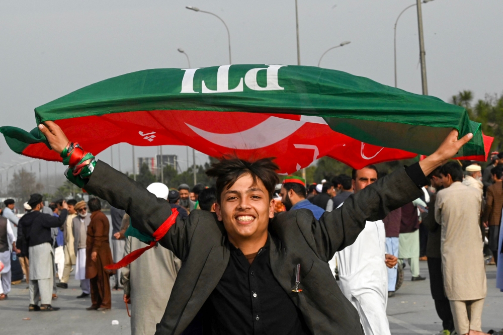 Supporters of Khan's Pakistan Tehreek-e-Insaf (PTI) party block Peshawar to Islambad highway as they protest against the alleged skewing in Pakistan's national election results, in Peshawar on February 12, 2024. (Photo by Abdul Majeed / AFP)