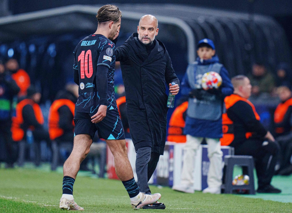 Manchester City's English midfielder #10 Jack Grealish is substituted by Manchester City's Spanish manager Pep Guardiola during the UEFA Champions League round of 16, first-leg football match between FC Copenhagen and Manchester City in Copenhagen, Denmark, on February 13, 2024. (Photo by Liselotte Sabroe / Ritzau Scanpix / AFP)