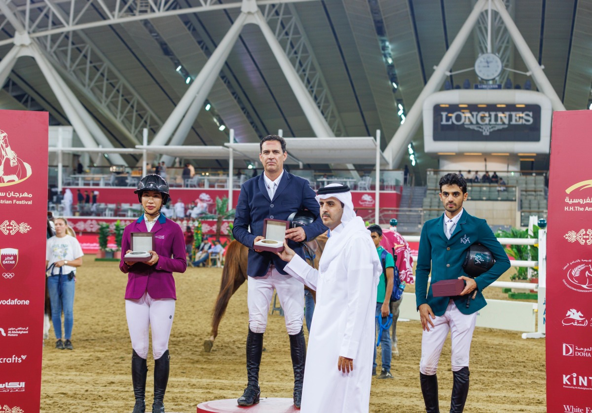 Qatar's International Referee Nasser Al Hajri hands the winner's award to Brazil’s Santiago Lambre. 
