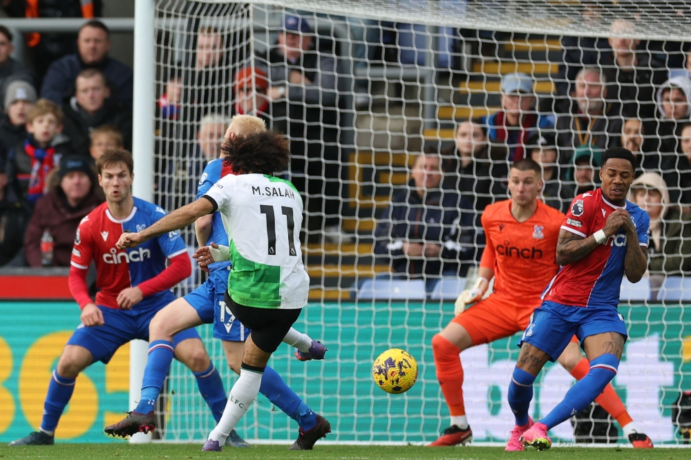 File photo: Liverpool's Egyptian striker #11 Mohamed Salah (C) shoots to score their first goal during the English Premier League football match between Crystal Palace and Liverpool at Selhurst Park in south London on December 9, 2023. (Photo by Adrian DENNIS / AFP)


