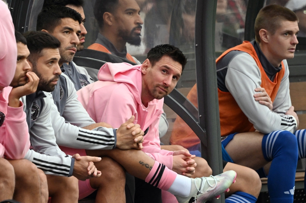 Inter Miami's Argentine forward Lionel Messi (C) sits on the bench during the friendly football match on February 4, 2024. (Photo by Peter Parks / AFP)

