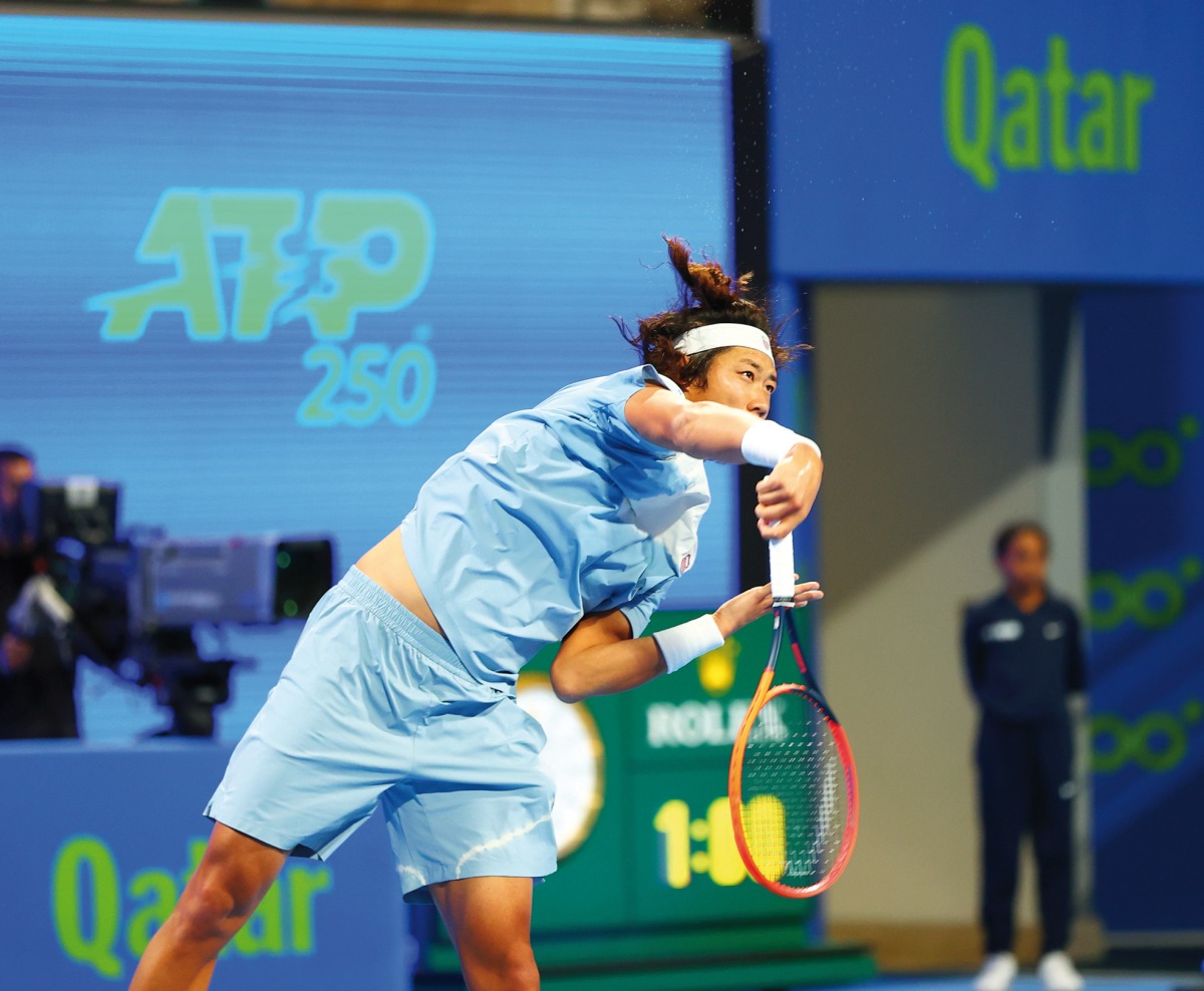 Zhang Zhizhen hits a return against Lorenzo Musetti during their Round of 32 match of the Qatar ExxonMobil Open, yesterday. 