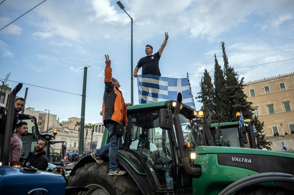 Greek farmers take part in a protest to demand financial aid in front of the Parliament in Athens on February 20, 2024. (Photo by Angelos TZORTZINIS / AFP)
