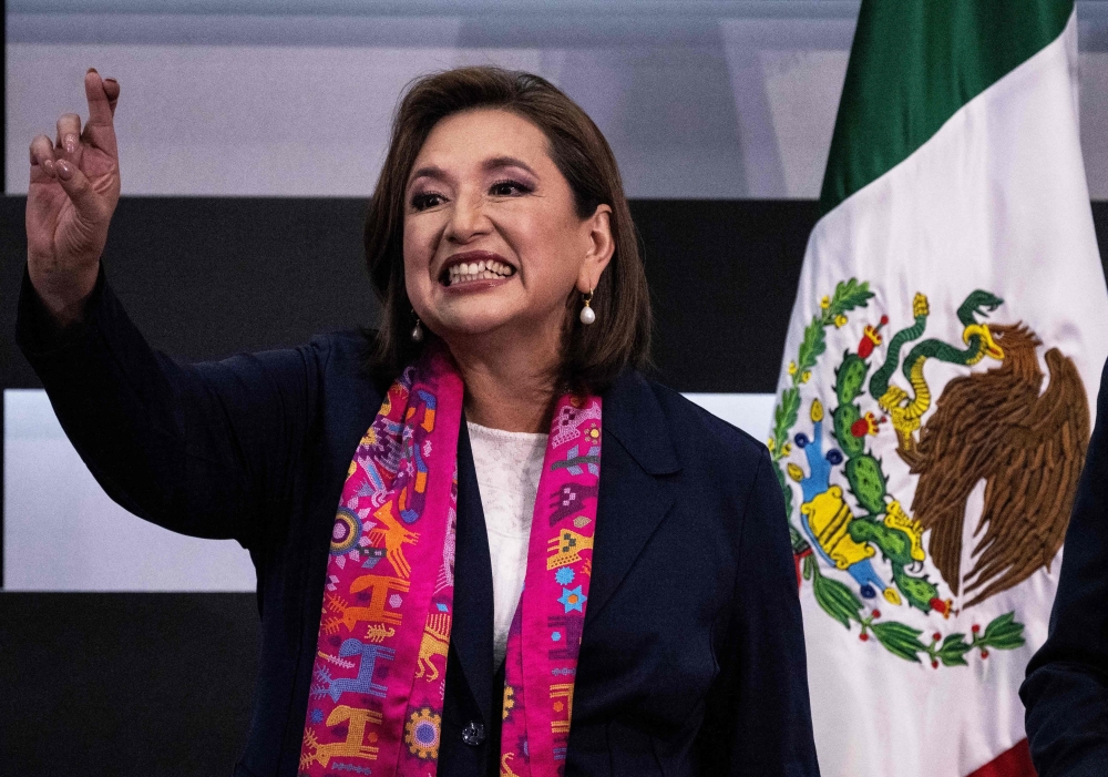 Opposition candidate Xochitl Galvez of the Fuerza y Corazon por Mexico coalition party gestures as she officially registers as a presidential candidate for the upcoming June 2, 2024, general election at the National Electoral Institute (INE) in Mexico City, Mexico, on February 20, 2024. (Photo by Carl DE Souza / AFP)