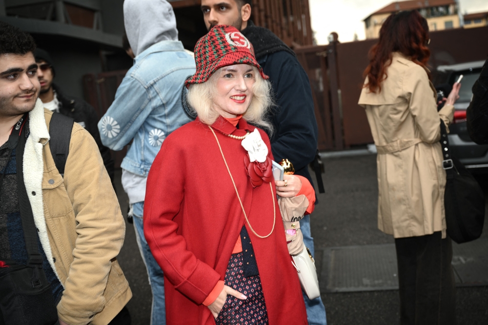 A person wearing a Gucci outfit is pictured in the street outside the Gucci collection show at the Milan Fashion Week Womenswear Autumn/Winter 2024-2025 on February 23, 2024 in Milan. (Photo by Marco Bertorello / AFP)
 