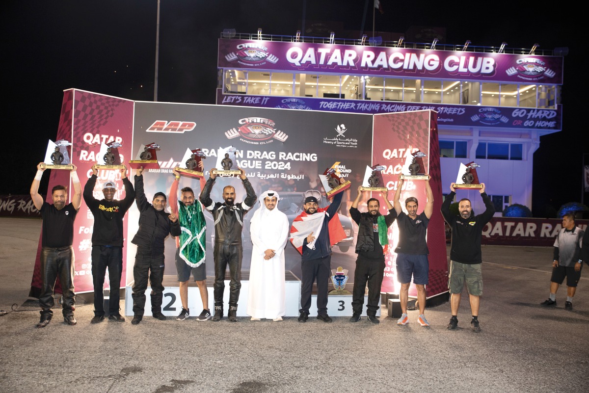 Qatar Racing Club Director Sheikh Jabor bin Khaled Al Thani poses with the champions of the respective event categories at the conclusion of the 2024 Arabian Drag Racing League season. 