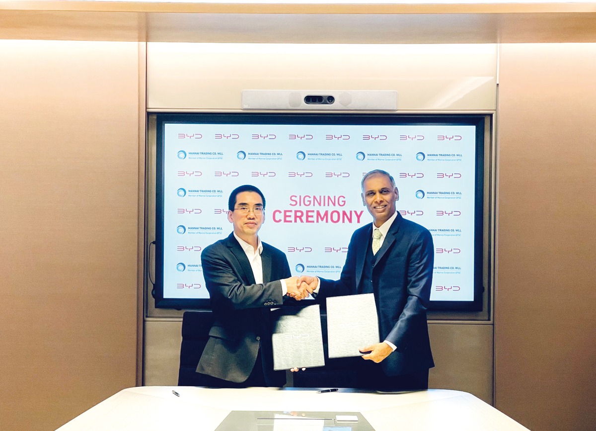 General Manager of BYD Middle East and Africa, AD Huang, and Rajesh Krishnan, Group General Manager of Mannai Automotive, during the signing event.