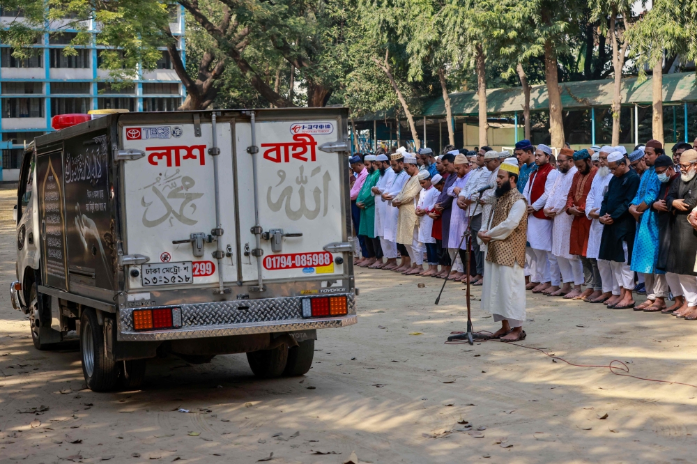 People offer funeral prayers for the victims who died in a restaurant blaze in Dhaka on March 1, 2024. (Photo by AFP)

