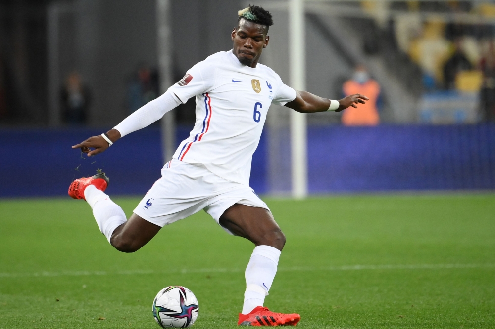 (FILES) France's midfielder Paul Pogba kicks the ball during the FIFA World Cup Qatar 2022 Group D qualification football match between Ukraine and France at the Olympic Stadium in Kiev on September 4, 2021. (Photo by FRANCK FIFE / AFP)
