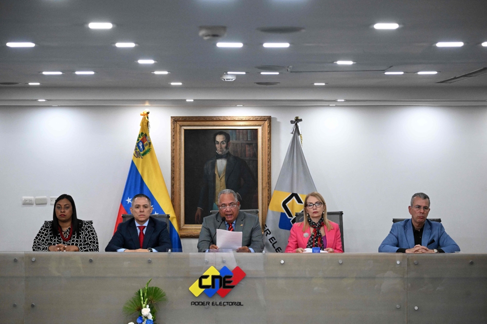 The President of Venezuela's National Electoral Council (CNE), Elvis Amoroso (C), speaks next to rectors Aime Nogal (L), Carlos Quintero (2-L), Rosalba Gil (2-R), and Juan Carlos Delpino (R) during a press conference at the CNE headquarters in Caracas on March 5, 2024. (Photo by Federico Parra / AFP)
