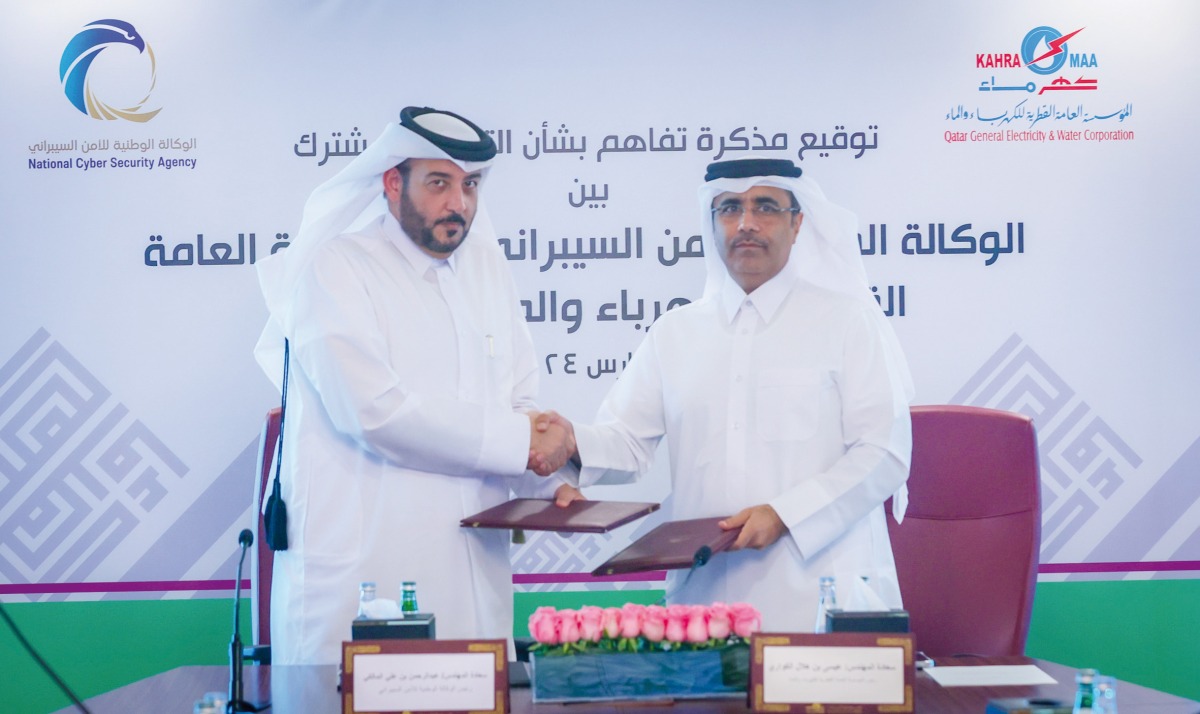 President of Kahramaa Eng Essa bin Hilal Al Kuwari (right) and President of NCSA Eng Abdul Rahman bin Ali Al Farahid Al Maliki exchanging documents after signing the agreement.