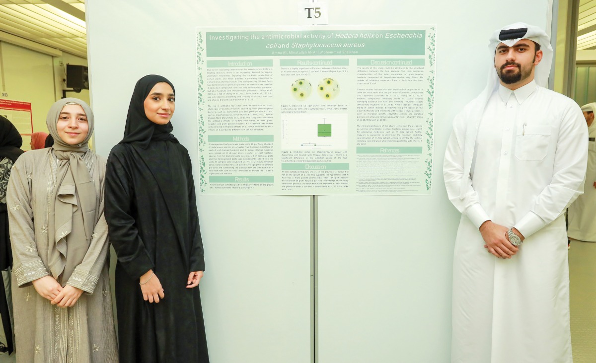 From left: WCM-Q pre-medical students Minatullah Al Ani, Amna Ali and Mohammed Shaikah with their research poster. 
