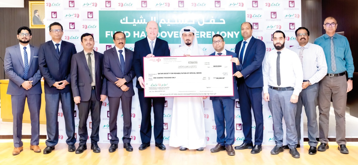 Regional Manager of Lulu Group in Qatar Shanavas Padiyath presents the cheque to Public Relations Coordinator of the QSRSN Dheyaa Khaled Alshmare.