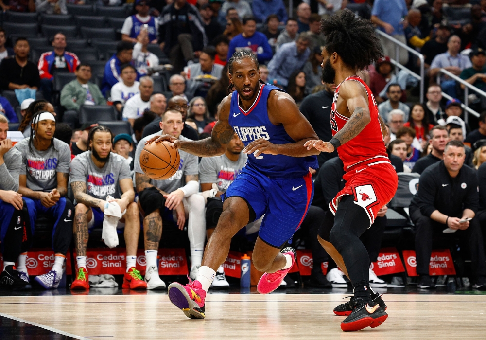 Kawhi Leonard #2 of the LA Clippers controls the ball against Coby White #0 of the Chicago Bulls in the second half at Crypto.com Arena on March 09, 2024 in Los Angeles, California. (Photo by RONALD MARTINEZ / GETTY IMAGES NORTH AMERICA / Getty Images via AFP)
