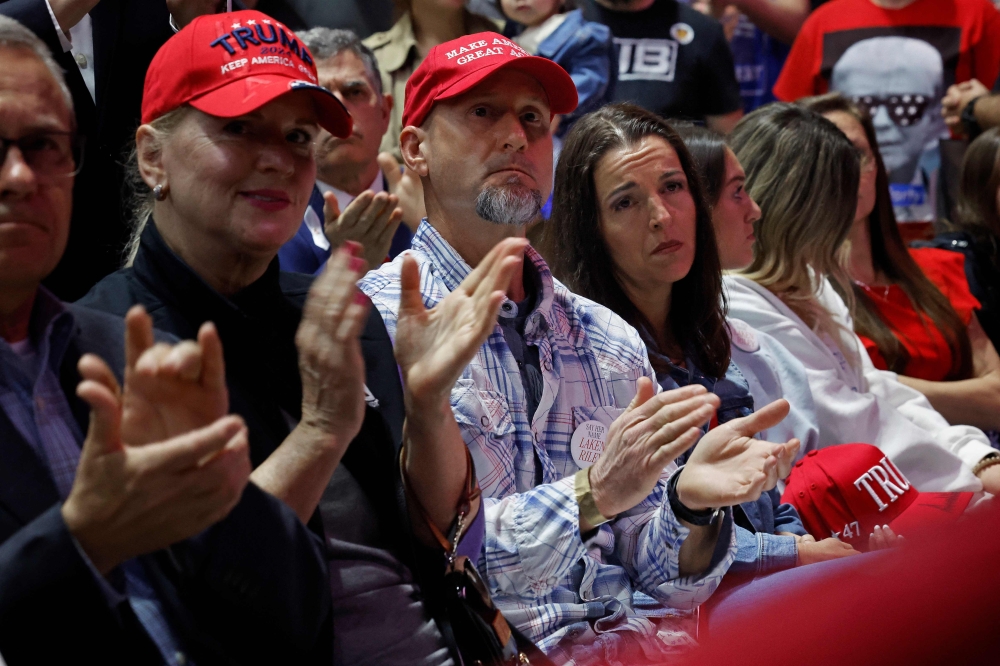 Laken Riley's parents Jason Riley (C) and Allyson Philips attend Republican presidential candidate and former U.S. President Donald Trump's campaign rally at the Forum River Center March 09, 2024 in Rome, Georgia. (Photo by CHIP SOMODEVILLA / GETTY IMAGES NORTH AMERICA / Getty Images via AFP)
