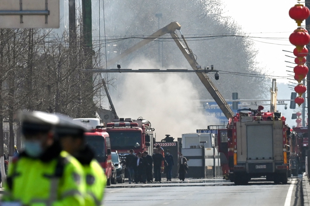 Firefighters work at the scene of a suspected gas explosion in Sanhe, in China's northern Hebei province on March 13, 2024. Photo by GREG BAKER / AFP