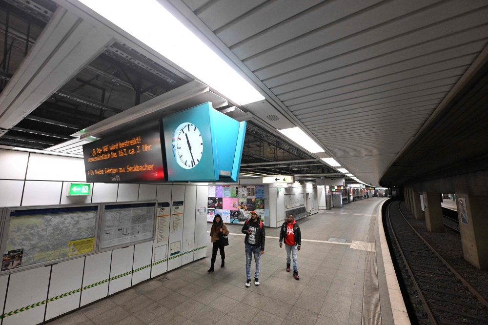 People look at a display announcing a strike for public transport in Frankfurt am Main, on March 13, 2024. Photo by Kirill KUDRYAVTSEV / AFP