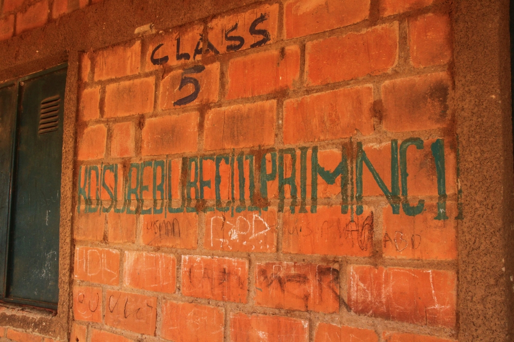 A general view of writing on a wall outside a classroom at Kuriga school in Kuririga on March 8, 2024, where more than 250 pupils kidnapped by gunmen. (Photo by Haidar Umar / AFP)
