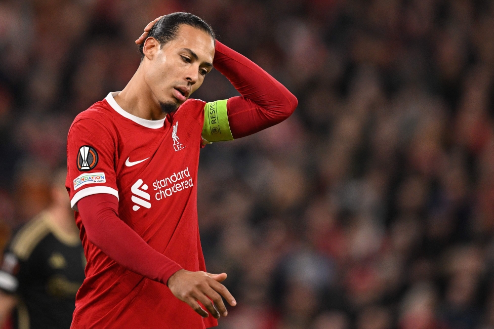 Liverpool's Dutch defender #04 Virgil van Dijk reacts during the UEFA Europa League round of 16 second leg football match between Liverpool and AC Sparta Praha at Anfield in Liverpool, north west England on March 14, 2024. (Photo by Oli SCARFF / AFP)