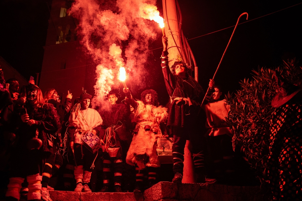 Revellers dressed as tanners and ghosts parade in costumes as they celebrate 