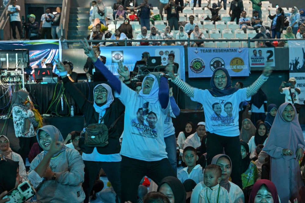 Supporters participate in an event of presidential candidate Prabowo Subianto and vice presidential candidate Gibran Rakabuming Raka at the Tennis Indoor Stadium Senayan in Jakarta on March 20, 2024. (Photo by Adek Berry / AFP)
