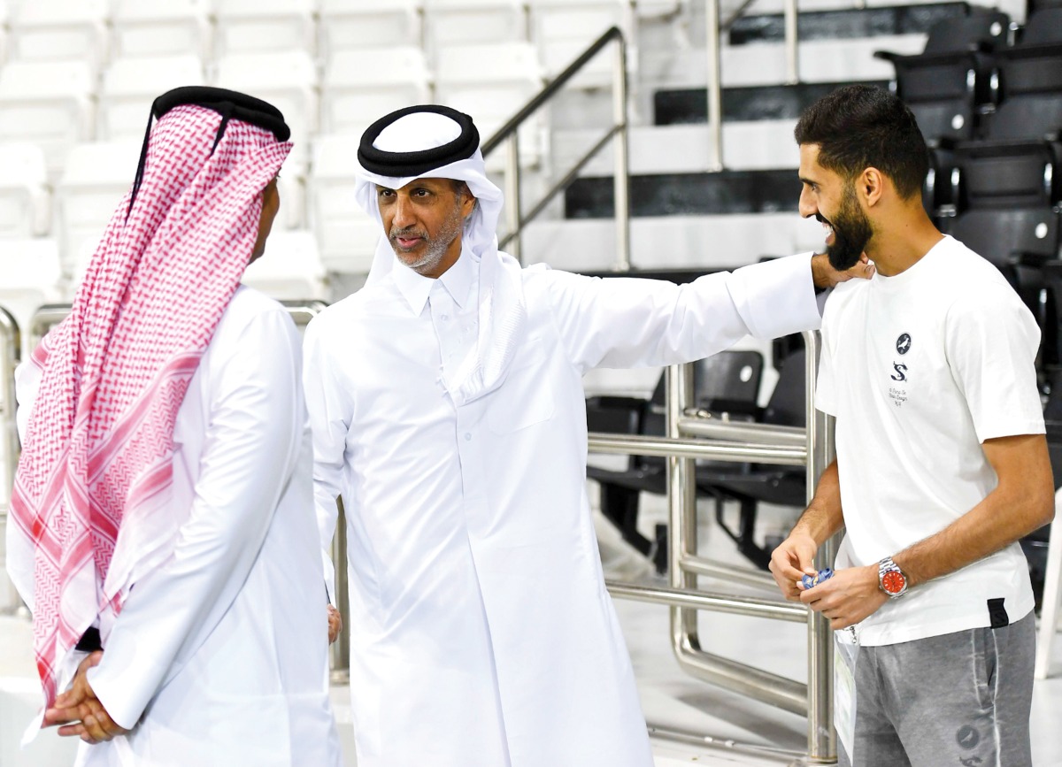 Minister of Sports and Youth H E Sheikh Hamad bin Khalifa bin Ahmed Al Thani with former Qatar captain Hassan Al Haydos (right), who recently retired from international football, on the sidelines of Qatar’s training session at Jassim Bin Hamad Stadium, yesterday.