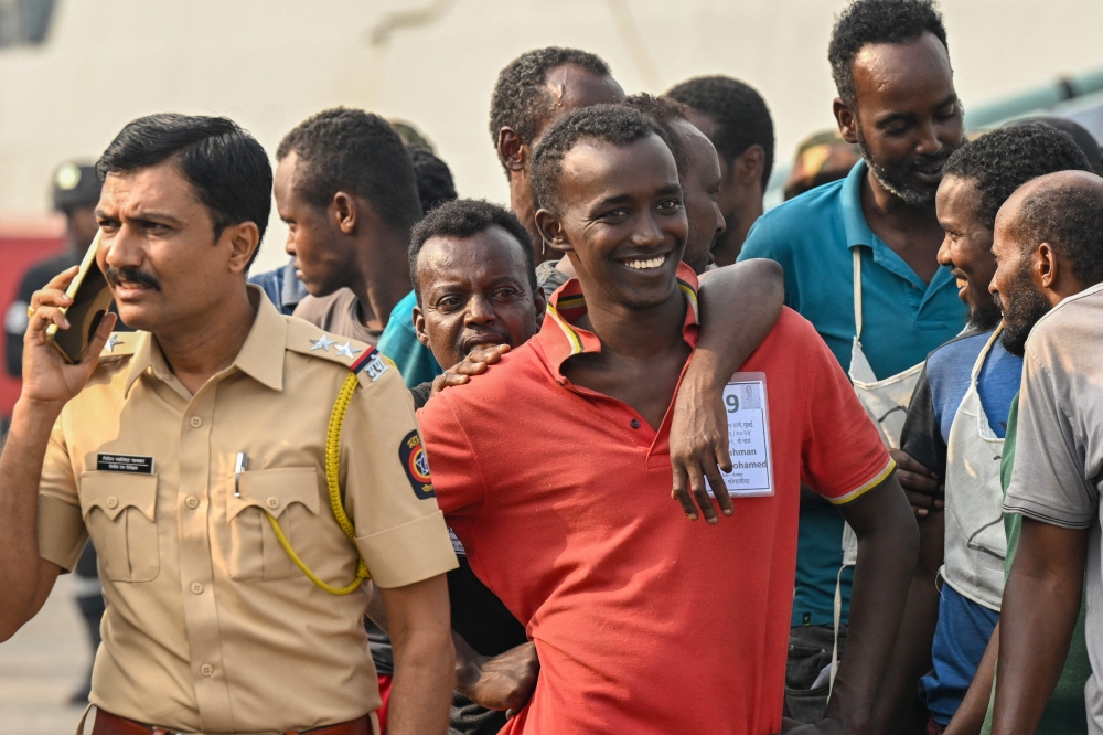 Accused Somali pirates wait to be transferred to police custody at the Indian naval dockyard in Mumbai on March 23, 2024. (Photo by Indranil Mukherjee / AFP)