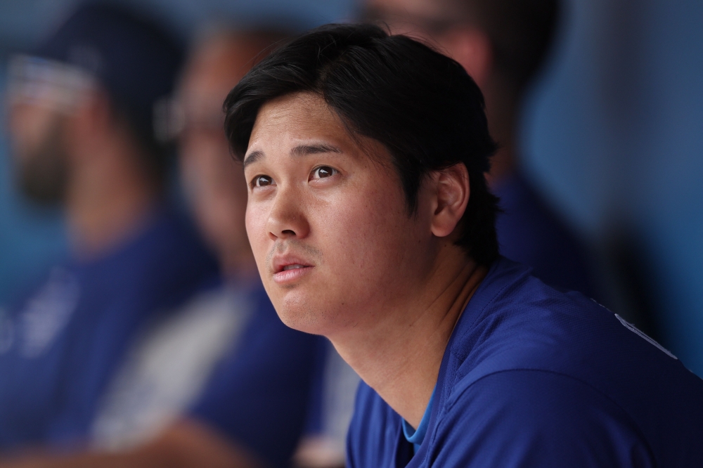 Shohei Ohtani #17 of the Los Angeles Dodgers looks on in the dugout during a game against the Chicago White Sox at Camelback Ranch on February 27, 2024 in Glendale, Arizona. (Photo by Christian Petersen / GETTY IMAGES NORTH AMERICA / Getty Images via AFP)