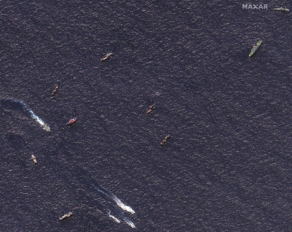 Handout satellite image released by Maxar Technologies on March 24, 2024 and dated March 23, 2024 shows Chinese and Philippine ships in waters where the Philippines said the China Coast Guard blocked their supply vessel and damaged it with water cannon in disputed waters of the South China Sea. (Photo by Handout / Satellite image 2024 Maxar Technologies / AFP) 
