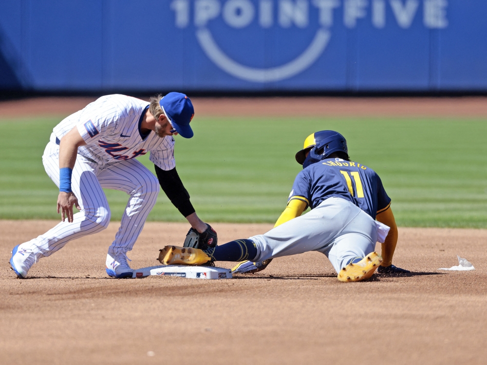 Jackson Chourio #11 of the Milwaukee Brewers steals second base under the tag attempt of Jeff McNeil #1 of the New York Mets during the top of the first inning in the home opener at Citi Field on March 29, 2024 in New York City. (Photo by Christopher Pasatieri / GETTY IMAGES NORTH AMERICA / Getty Images via AFP)