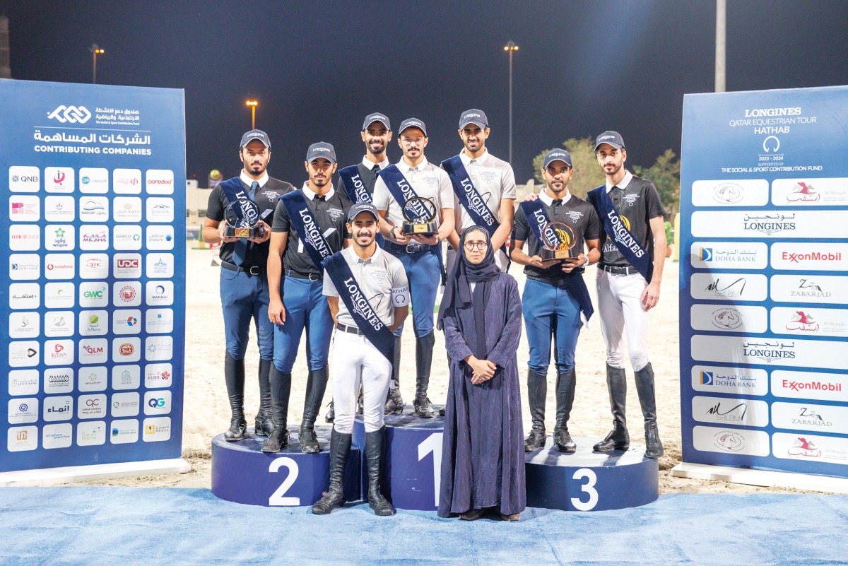 The podium winners of the medium tour event (left), and the medium tour team event, pose for a photograph with Deputy Head of Sports Committee Haya Al Naimi.