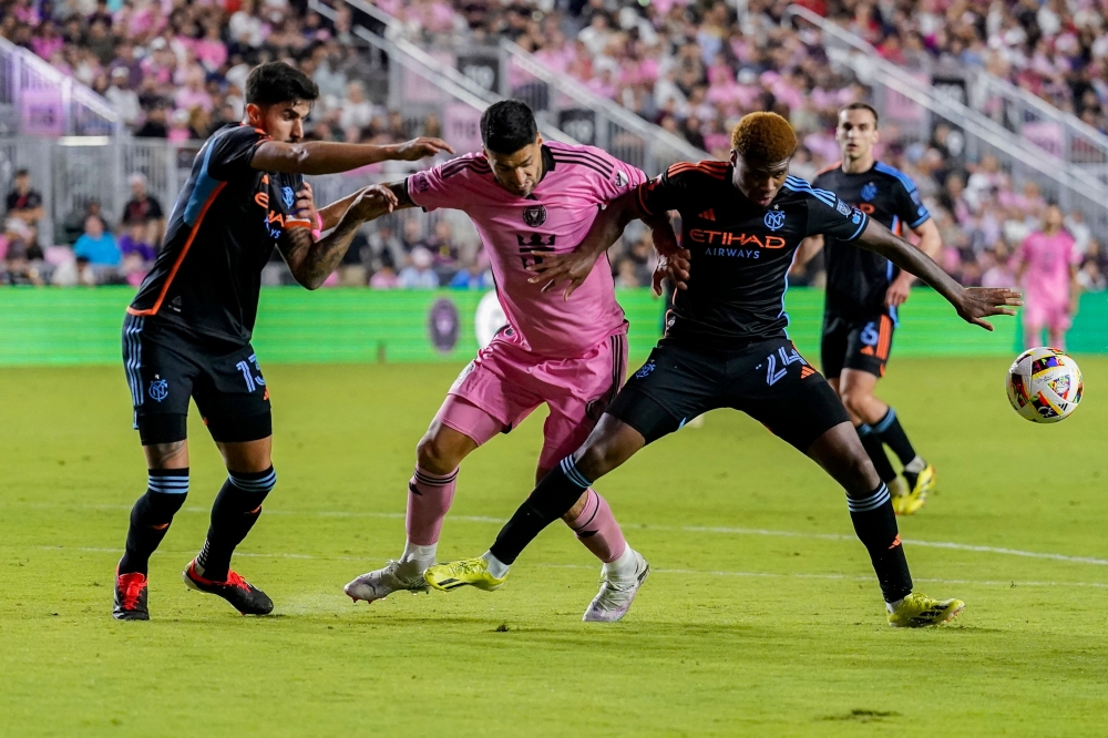 Luis Suarez of Inter Miami CF and Tayvon Gray of New York City FC compete for the ball during the second half at DRV PNK Stadium on March 30, 2024 in Fort Lauderdale, Florida. Rich Storry/Getty Images/AFP 
