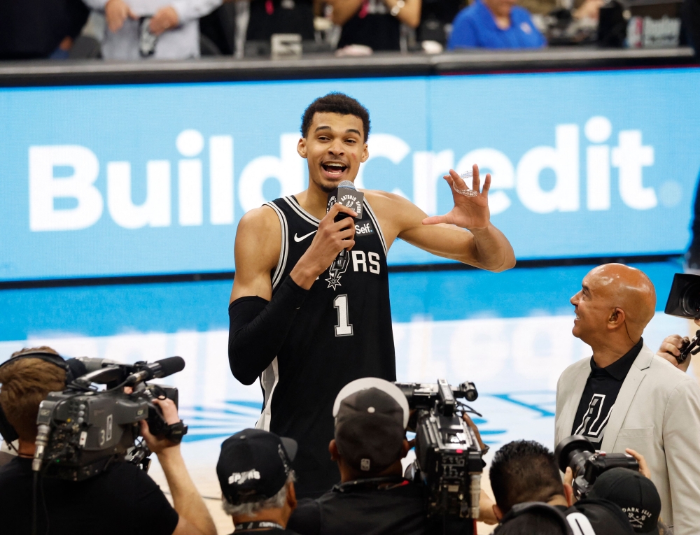 Victor Wembanyama #1 of the San Antonio Spurs address the crowd after they defeated the New York Knicks at Frost Bank Center on March 29, 2024 in San Antonio, Texas. (Photo by Ronald Cortes / GETTY IMAGES NORTH AMERICA / Getty Images via AFP)

