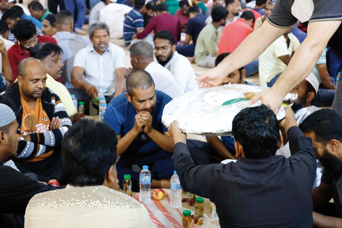 People gather for Iftar meal at a tent arranged by the Ministry of Awqaf and Islamic Affairs.