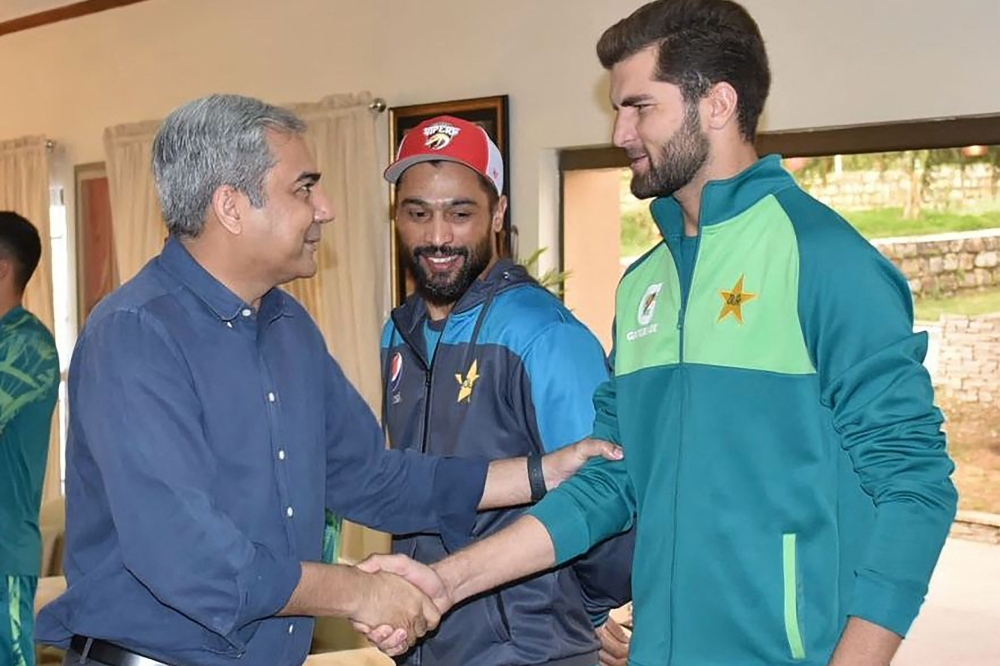 :This handout photograph taken and released by Pakistan痴 Cricket Board (PCB) on April 1, 2024, shows PCB Chairman Mohsin Naqvi (L) meets with cricketer Shaheen Shah Afridi (R) during his visit Pakistan team fitness camp being conducted by trainers from the Pakistan Army in Kakul, Abbottabad eastern Khyber Pakhtunkhwa province. (Photo by Pakistan Cricket Board (PCB) / AFP)