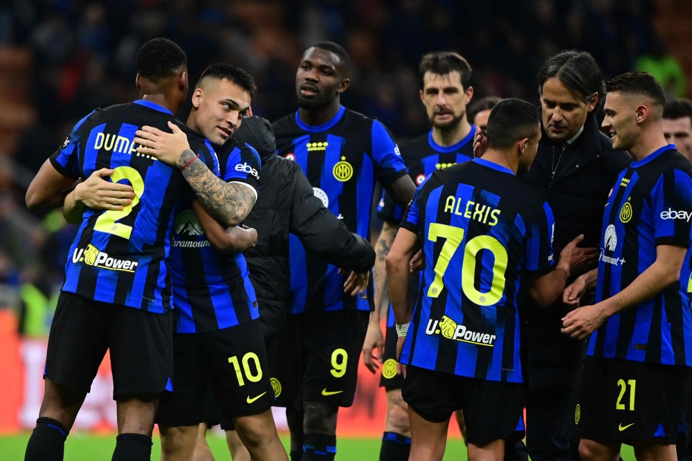 Inter Milan's players celebrate their 2-0 victory at the end of the Italian Serie A football match between Inter Milan and Empoli in Milan, on April 1, 2024. (Photo by Piero CRUCIATTI / AFP)
