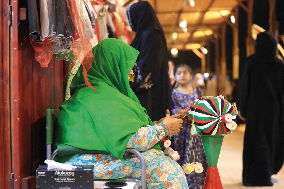 An Emirati woman weaves thread in the Al Talli method, a traditional local weaving technique, during an annual heritage festival in Al Ain. 