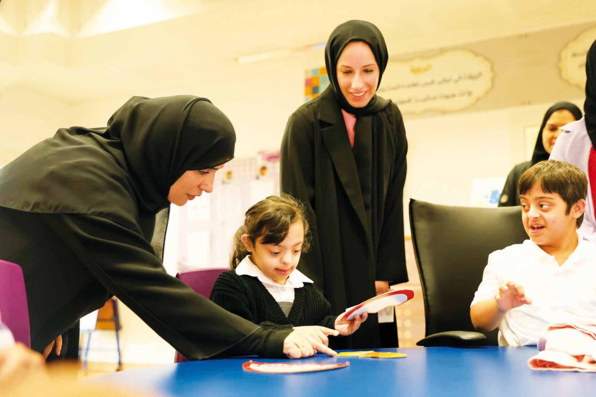 Minister of Education and Higher Education H E Buthaina bint Ali Al Jabr Al Nuaimi interacts with children at Al-Hidayah School for People with Special Needs in Al Sakhama.
