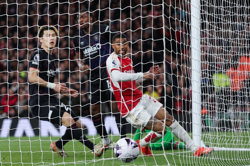 Luton Town's Japanese defender #27 Daiki Hashioka (L) reacts after scoring an owngoal during the English Premier League football match between Arsenal and Luton Town at the Emirates Stadium in London on April 3, 2024. (Photo by Adrian DENNIS / AFP)