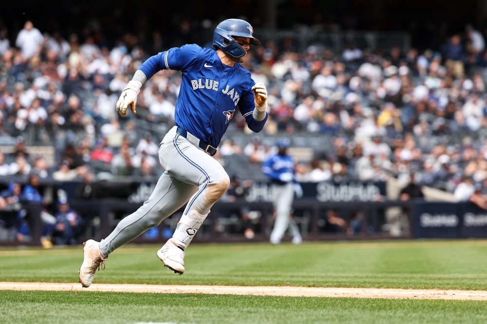 Cavan Biggio #8 of the Toronto Blue Jays hits a double during the fourth inning of the game against the New York Yankees during the home opener at Yankee Stadium on April 05, 2024 in New York City. (Photo by Dustin Satloff / GETTY IMAGES NORTH AMERICA / Getty Images via AFP)