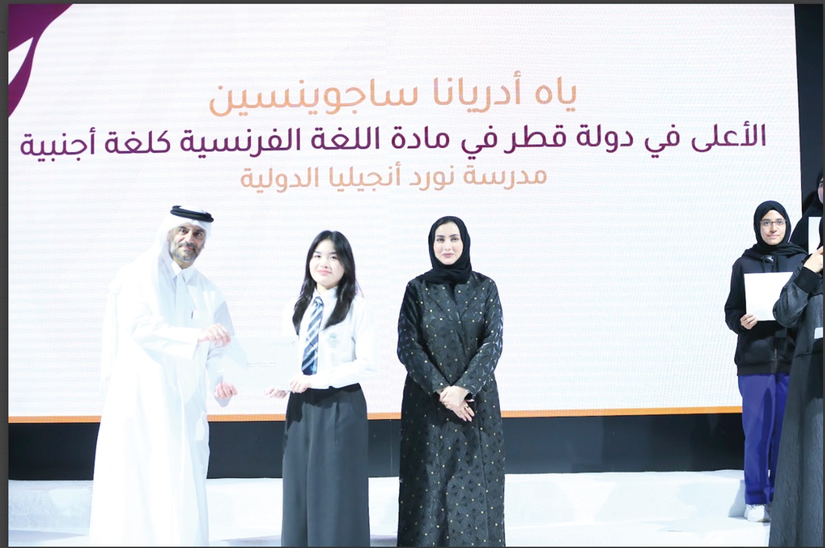 Yyah Adriana Mendoza Saguinsin receiving her award from officials.