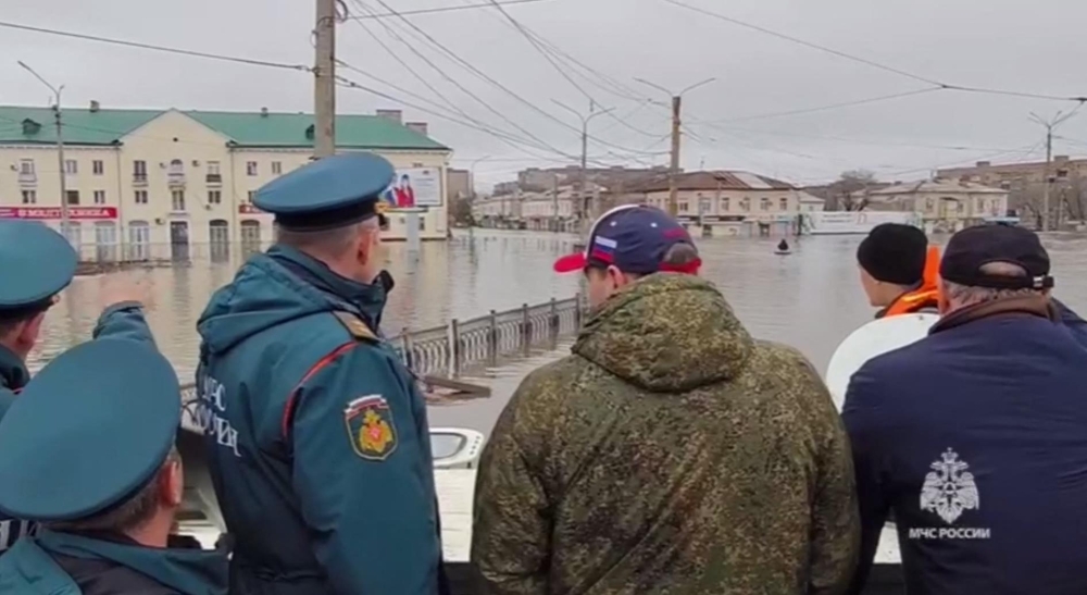 This photo taken from a video released by the Russian Emergency Situations Ministry on April 7, 2024 shows rescuers inspecting a flooded area in the town of Orsk, Orenburg region, southeast of the southern tip of the Ural Mountains. (Photo by Handout / Russian Emergencies Ministry / AFP)