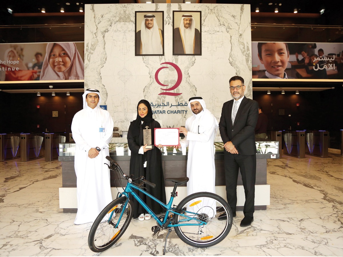 Officials pose for a photo during the ‘Build a Bike’ initiative.