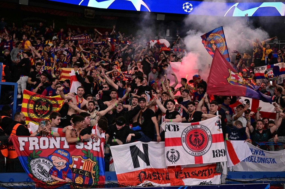 Barcelona's supporters cheer their team on from the stands during the UEFA Champions League quarter final first leg football match between Paris Saint-Germain (PSG) and FC Barcelona at the Parc des Princes stadium in Paris on April 10, 2024. (Photo by Miguel Medina / AFP)
