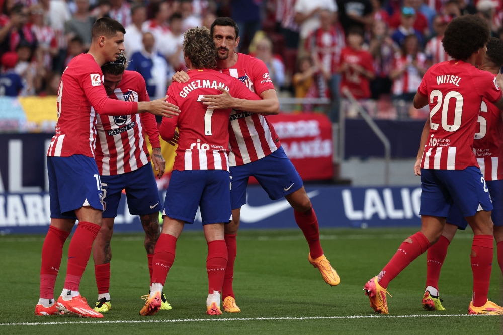 Atletico Madrid's French forward #07 Antoine Griezmann celebrates scoring his team's third goal during the Spanish league football match between Club Atletico de Madrid and Girona FC at the Metropolitano stadium in Madrid on April 13, 2024. (Photo by Thomas COEX / AFP)
