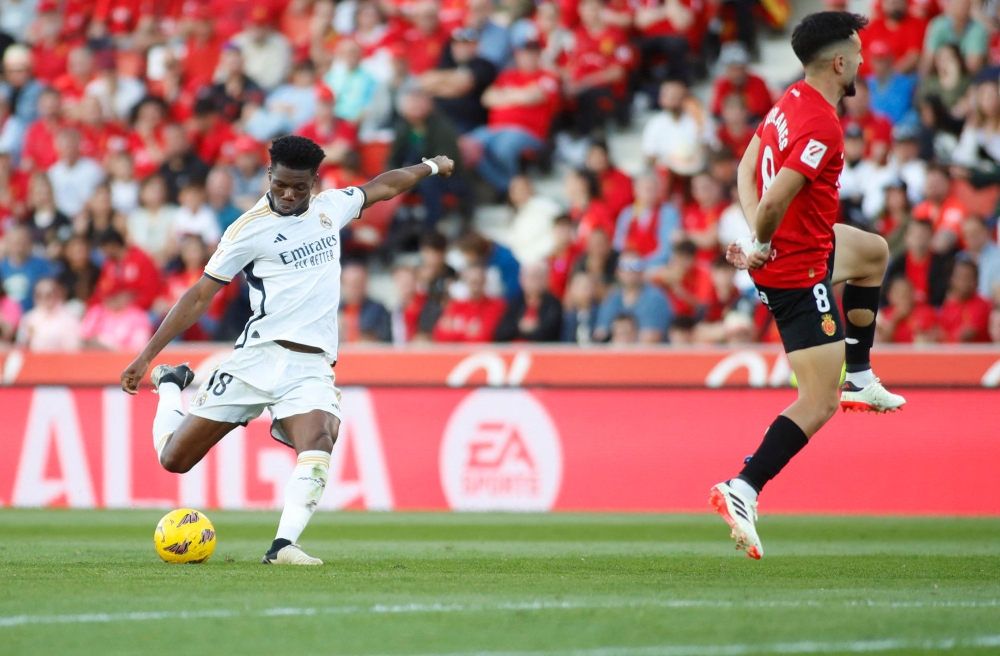Real Madrid's French midfielder #18 Aurelien Tchouameni shots to score his team's first goal during the Spanish league football match between RCD Mallorca and Real Madrid CF at the Mallorca Son Moix stadium in Palma de Mallorca on April 13, 2024. (Photo by JAIME REINA / AFP)
